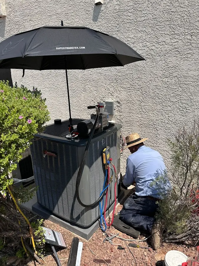 HVAC technician performing outdoor AC maintenance in Opelousas